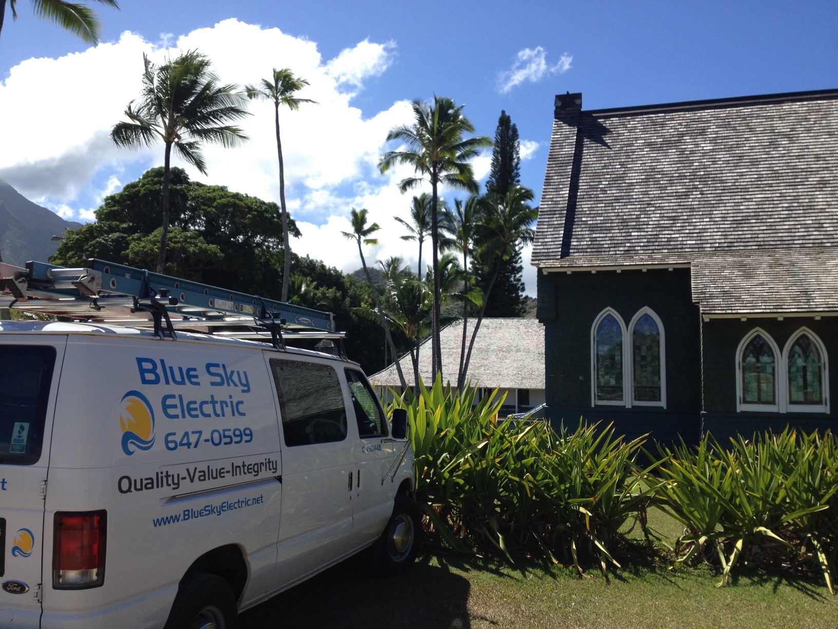 Blue Sky Electric work van parked outside a historic church.