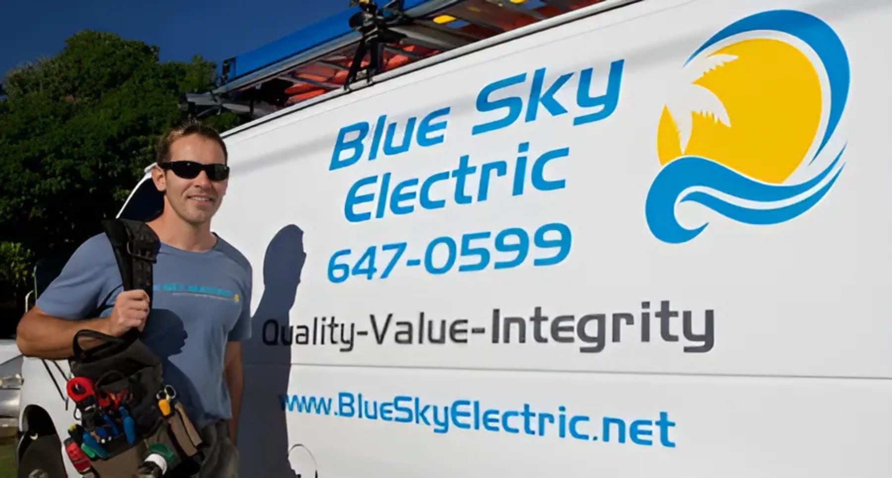 Blue Sky Electric owner smiling in front of company work van.